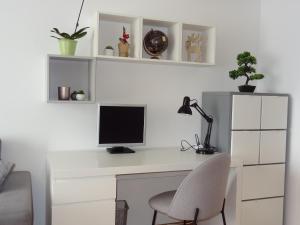 萨格勒布Well-equipped apartment with free parking的一张带电脑显示器和椅子的白色书桌