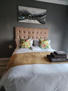 东伦敦Recoupe的卧室配有一张白色大床和床头板