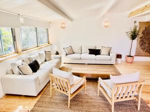塞勒玛Salema Eco Camp - Sustainable Camping & Glamping的客厅配有白色的沙发和椅子