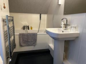 法尔茅斯Headlands - Room Only Accommodation的浴室配有盥洗盆和浴缸。