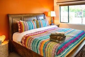 塞多纳Desert Mermaid in Sedona的一间卧室配有一张带彩色毯子和窗户的床。