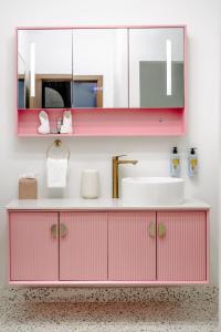 夏洛特阿马利亚The Pink Palm Hotel - Adults Only的粉红色的浴室设有水槽和镜子