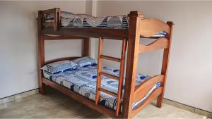 佩雷拉Hostal Casa Amatista的双层床配有梯子,双层床配有双层床垫。