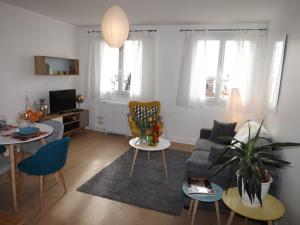 欧里亚克Appartement Aurillac, 2 pièces, 2 personnes - FR-1-742-389的客厅配有沙发和桌子
