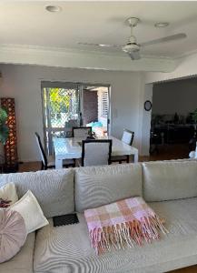黄金海岸Room in a Family home的带沙发的客厅和用餐室