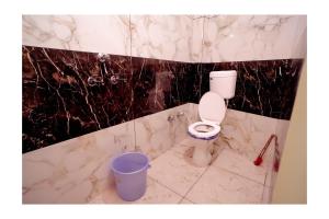 乌贾因Rajdarshan Hotel的一间带卫生间和垃圾桶的浴室