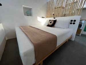 KlimaWhite Coral的一间卧室配有一张大床和木制床头板