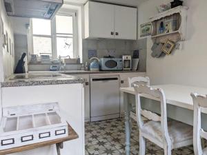 班贝格Kleine Villa - ganzes Stadthäuschen für Gruppen Familien oder nur zu Zweit的厨房配有白色橱柜和桌椅