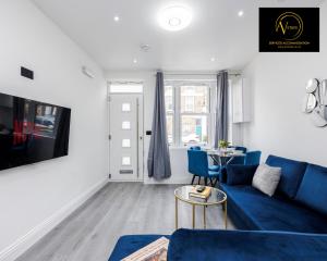 伦敦2 Bedroom Apartment by AV Stays Short Lets Southwark London的客厅配有蓝色的沙发和桌子