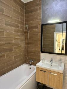 阿斯塔纳Стильная квартира в ЖК бизнес класса AVENUE 5的一间带水槽、浴缸和镜子的浴室