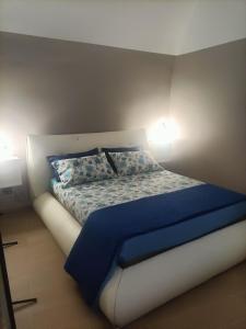 圣埃拉莫因科莱Il rifugio del folletto的卧室内的一张带蓝色床单和枕头的床