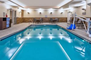 WalkerFairfield by Marriott Inn & Suites Grand Rapids North的大楼内的一个蓝色海水游泳池