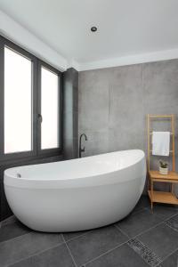 约阿尼纳THE URBANIST •inner city residences•的浴室内设有大型白色浴缸。