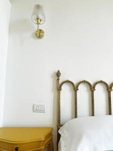 墨西拿B&B ISOLA Messina的卧室配有一张床和墙上的灯。