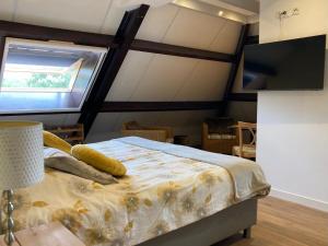 MolkwerumB&B Stations Koffiehuis的一间卧室设有一张床、一个窗口和一台电视