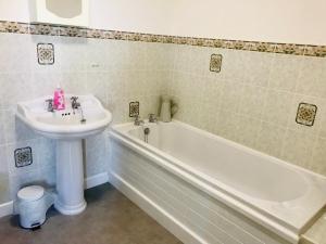 布兰斯福德Bransford Farm Fishery & B & B的浴室设有水槽和白色水槽旁的浴缸。