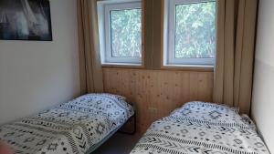沃尔弗哈Huisjedelinde的带2扇窗户的客房内的2张床