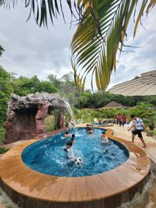 Ban Khao Rup Changสงขลาคีรี รีสอร์ท SongkhlaKeeree Resort的一群人,在游泳池里,有足球球