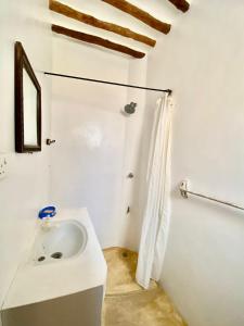 拉穆Beautiful Mafriza Apartment的白色的浴室设有水槽和淋浴。