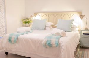 格拉夫-里内特The River Bend Cottages的卧室配有白色床和毛巾