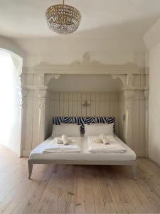 米尔施塔特施特莱恩茨别墅酒店的客房内的一张带两个枕头的白色床