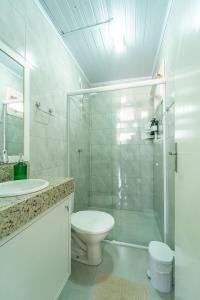 邦雅尔丁-达塞拉Chalés da Tribo的白色的浴室设有卫生间和淋浴。