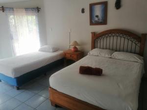 El CarmenCasa Las Animas的一间卧室配有两张床、一盏灯和镜子