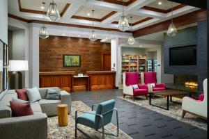 亚特兰大亚特兰大中区惠庭套房酒店的客厅配有沙发、椅子和电视