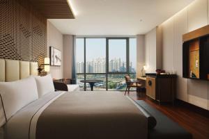 杭州杭州金沙湖和达希尔顿嘉悦里酒店的酒店客房设有一张床和一个大窗户