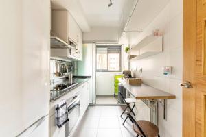 马德里Home Sweet Home的一间小厨房,配有白色的橱柜和柜台