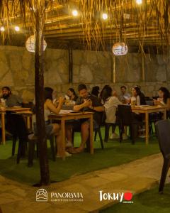 曼克拉Panorama garden inn的一群坐在餐厅桌子上的人