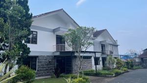 PanyaweuyanGreen Hill Resort Kemuning的砖墙白色房子
