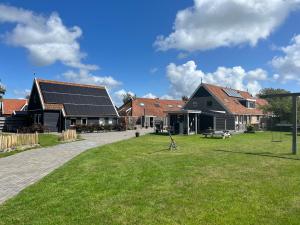 泰尔斯海灵It Winkelhûs的一群在草地上设有太阳能电池板的房屋