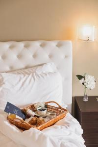 贝特纳斯科Villa Antica Colonia - Lake Orta - Suite Apartments Adults Only - SPA & Wellness的床上一篮子的食物和面包