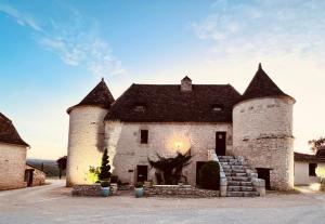 罗卡马杜尔Hôtel Les Vieilles Tours Rocamadour的一座古老的城堡,上面有两座塔楼