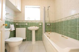 奇平卡姆登Badgers End的浴室配有卫生间、盥洗盆和浴缸。