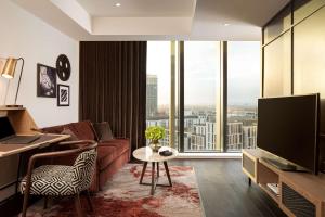 伦敦The Gantry London, Curio Collection By Hilton的带沙发和大窗户的客厅
