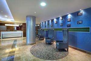 伊斯坦布尔卡亚什尔希尔顿欢朋酒店的一间设有椅子和蓝色墙壁的等候室