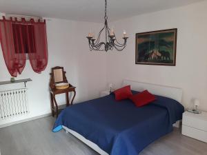 维纳利亚瑞勒House Vittone Venaria Reale的一间卧室配有蓝色的床和吊灯。