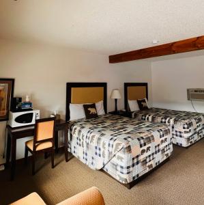 科迪度假小屋汽车旅馆的酒店客房配有两张床和一张书桌