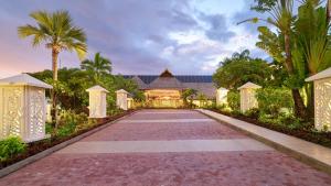 帕皮提Hilton Hotel Tahiti的通往棕榈树房屋的车道