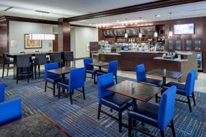 普莱诺达拉斯普莱诺/理查森万怡酒店 的一间设有蓝色桌椅和柜台的餐厅