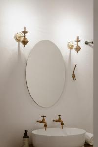 西蒙镇Bonne Esperance, Simon's Town的浴室水槽设有镜子和2个水龙头