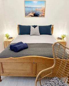 Encounter BayBay Breeze Cottage的一张床上有蓝色枕头的睡床