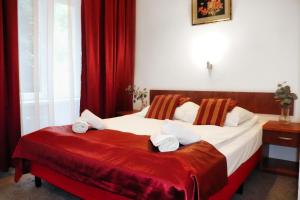 弗罗茨瓦夫罗特哈斯酒店的酒店客房,配有两张带红色窗帘的床