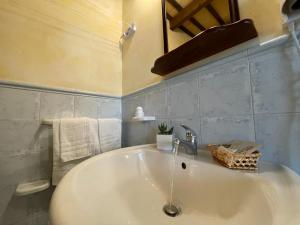 圣维托罗卡波Ai Dammusi Rooms的浴室设有白色水槽和镜子