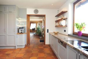拜尔斯布龙Casa Cara的厨房配有白色橱柜和瓷砖地板。