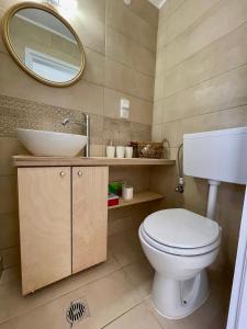 圣马太奥斯ilianas place的一间带卫生间、水槽和镜子的浴室