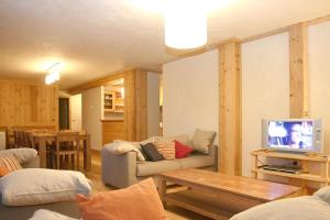 莱德萨阿尔卑斯Vacancéole - Résidence Cortina的带沙发和电视的客厅