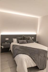 Casa Tía Pepa的卧室配有一张白色墙壁的大床